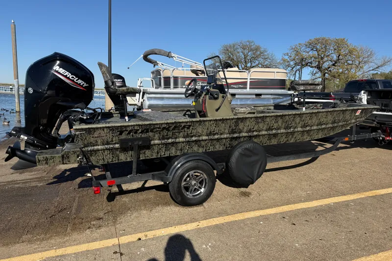 Slide: The Image of 2025 Tracker Grizzly 1860 MVX CC boat with Mercury engine on trailer. - 60
