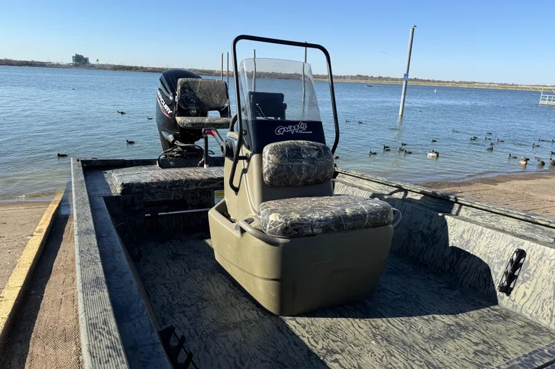 Slide: The Image of 2025 Tracker Grizzly 1860 MVX CC boat on a lake with ducks nearby. - 63