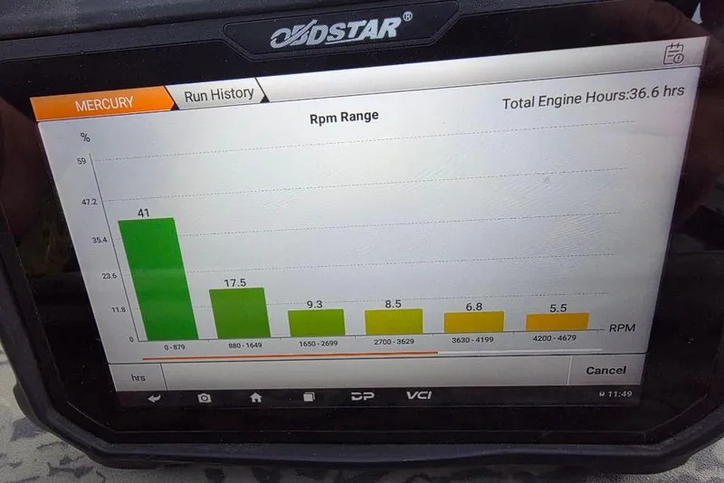 Slide: The Image of 2025 Tracker Grizzly 1860 MVX CC boat with outboard motor in parking lot. - 7