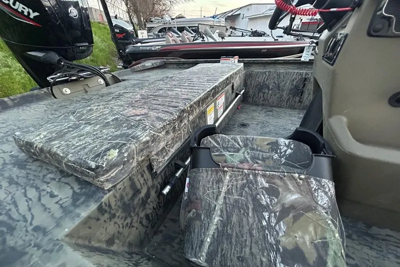 Slide: The Image of 2025 Tracker Grizzly 1860 MVX CC boat on trailer, parked outdoors. - 9