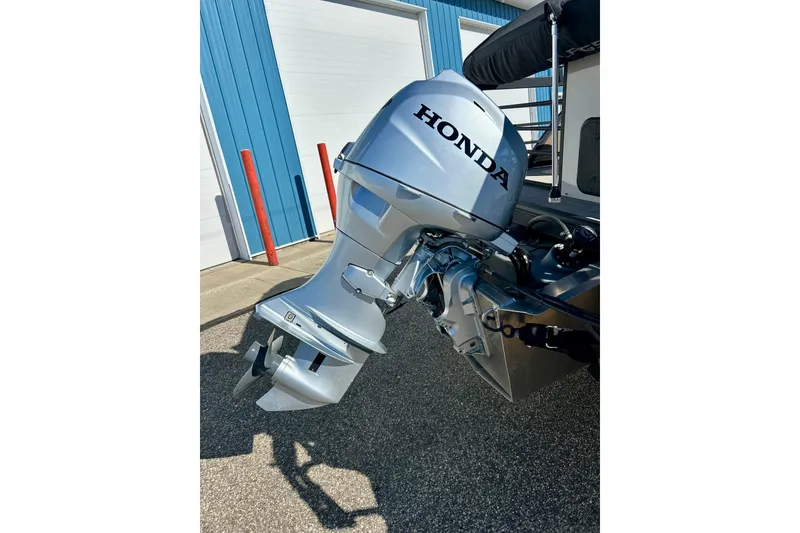 Slide: The Image of Silver Honda outboard motor on 2023 Flagship 200 Lounge Lounger boat. - 11