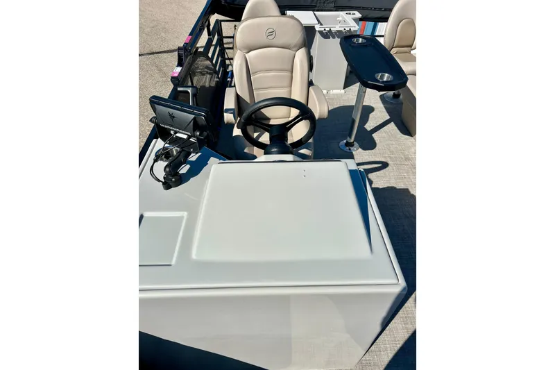 Slide: The Image of 2023 Flagship 200 Lounge Lounger boat interior with steering wheel and seating area. - 20