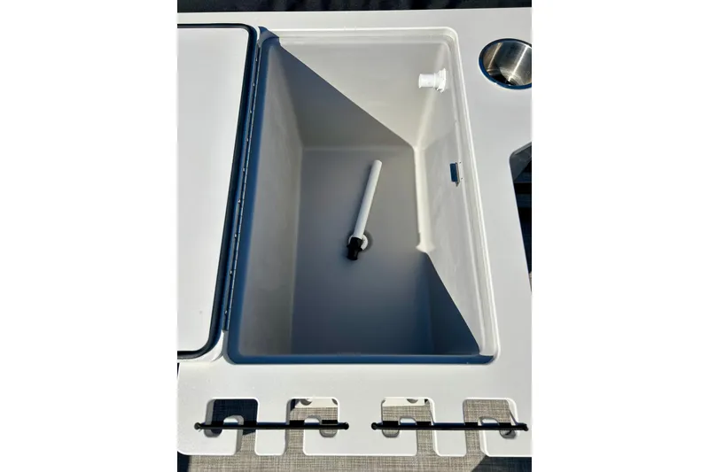 Slide: The Image of Open storage compartment on 2023 Flagship 200 Lounge Lounger boat, featuring a sleek design. - 25