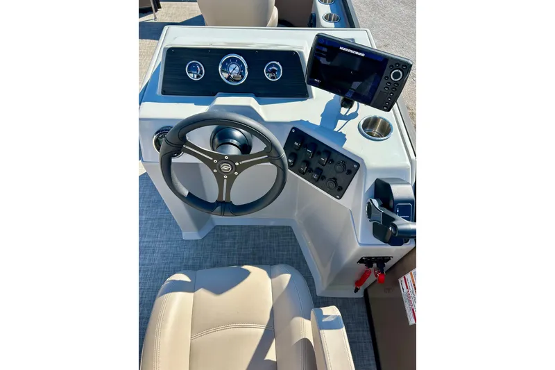 Slide: The Image of 2023 Flagship 200 Lounge Lounger boat dashboard with steering wheel and control panel. - 29