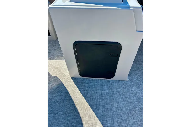 Slide: The Image of 2023 Flagship 200 Lounge Lounger storage compartment on textured flooring. - 35