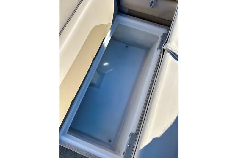Slide: The Image of Open storage compartment in 2023 Flagship 200 Lounge Lounger boat, featuring beige upholstery. - 38