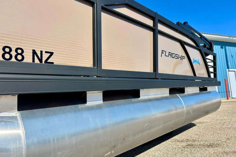 Slide: The Image of 2023 Flagship 200 Lounge Lounger pontoon boat, side view, with sleek design and branding. - 42