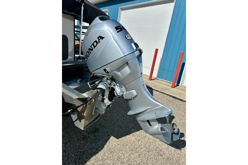 Slide: The Image of Outboard motor on 2023 Flagship 200 Lounge Lounger, parked near blue building. - 6