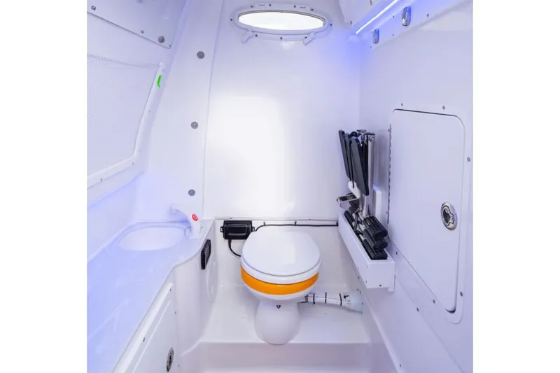 Slide: The Image of Manufacturer Provided Image: Interior of 2026 Sea Hunt Ultra 285 SE boat, featuring a compact marine toilet. - 9