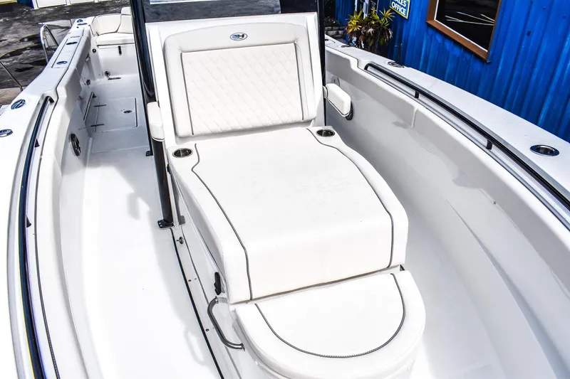 Slide: The Image of 2026 Sea Hunt Ultra 285 Coffin Box boat interior with white seating and sleek design. - 10
