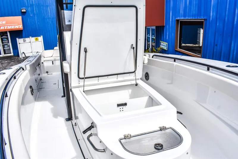 Slide: The Image of 2026 Sea Hunt Ultra 285 Coffin Box boat interior with open storage compartment. - 11