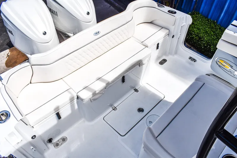 Slide: The Image of 2026 Sea Hunt Ultra 285 Coffin Box boat interior with white seating and Yamaha engines. - 3