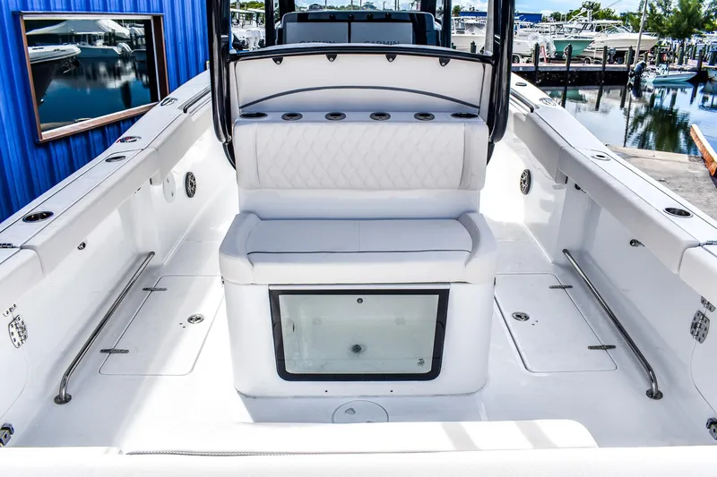 Slide: The Image of 2026 Sea Hunt Ultra 285 Coffin Box boat interior with white seating and storage. - 4