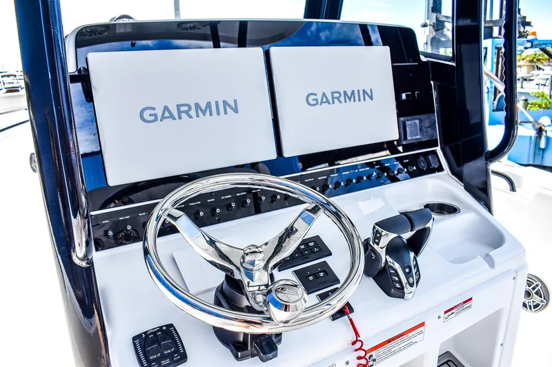 Slide: The Image of 2026 Sea Hunt Ultra 285 Coffin Box boat console with Garmin displays and steering wheel. - 6