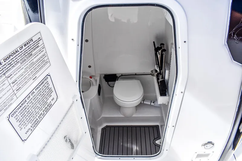 Slide: The Image of 2026 Sea Hunt Ultra 285 Coffin Box boat interior with compact marine toilet. - 8