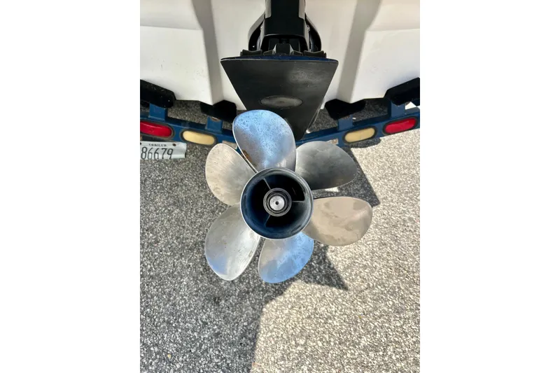 Slide: The Image of 2000 Sea Ray 240 Sundeck boat on trailer, rear view with propeller visible. - 10