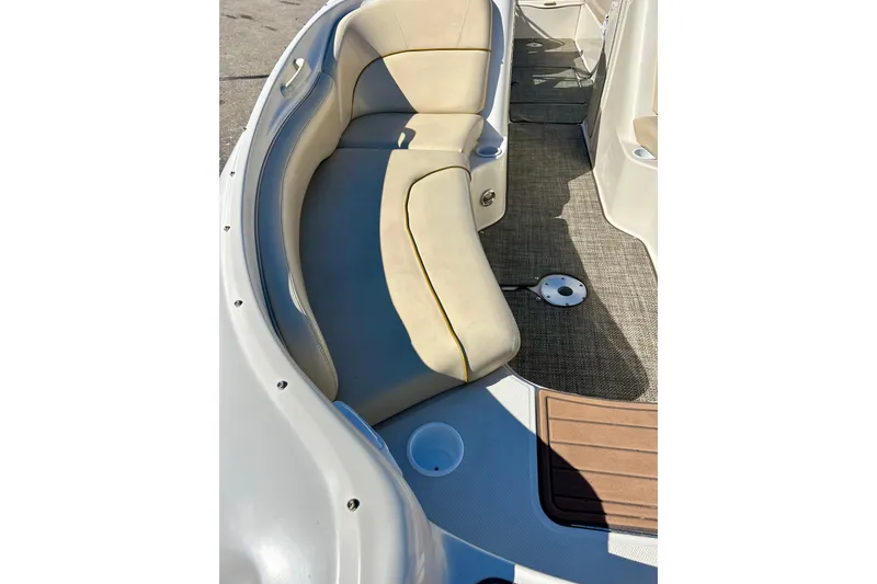 Slide: The Image of Interior view of a 2000 Sea Ray 240 Sundeck boat with beige seating and wooden flooring. - 14