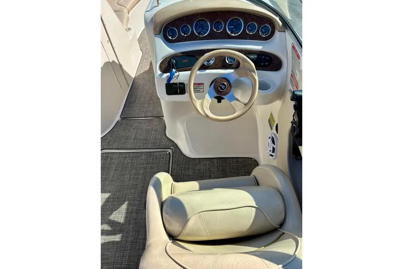 Slide: The Image of 2000 Sea Ray 240 Sundeck interior with storage compartment and cup holders. - 19