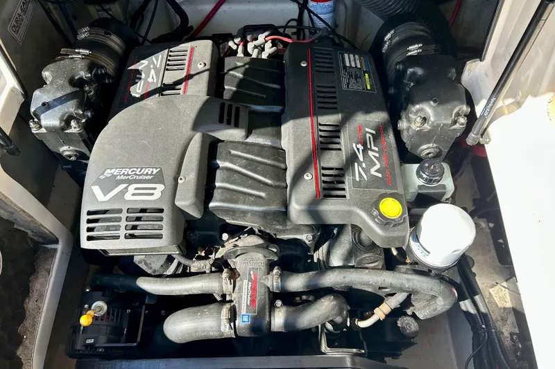 Slide: The Image of 2000 Sea Ray 240 Sundeck boat seating with beige upholstery and cup holder. - 26