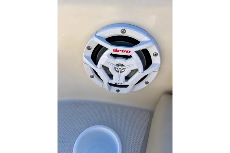 Slide: The Image of 2000 Sea Ray 240 Sundeck interior storage compartment with beige and blue accents. - 29