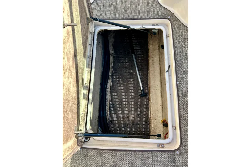 Slide: The Image of Interior view of 2000 Sea Ray 240 Sundeck boat with carpeted flooring. - 35