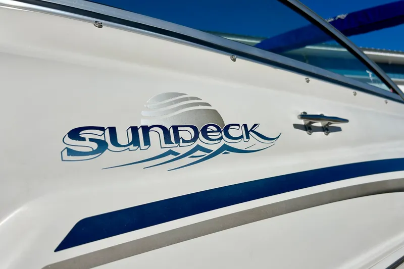 Slide: The Image of Storage compartment on 2000 Sea Ray 240 Sundeck boat with carpeted flooring. - 42