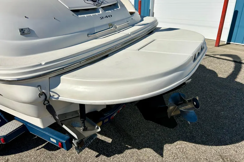 Slide: The Image of Close-up of 2000 Sea Ray 240 Sundeck boat logo on white hull. - 43