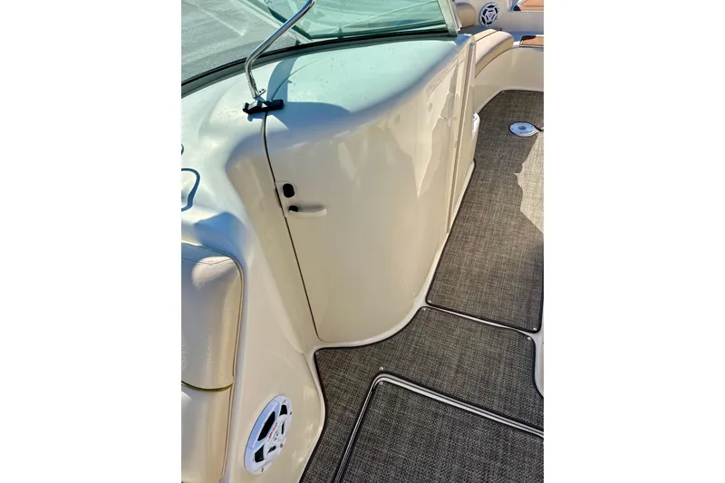 Slide: The Image of Storage compartment in 2000 Sea Ray 240 Sundeck boat, featuring secure straps and clean interior. - 46