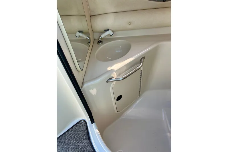 Slide: The Image of Interior of 2000 Sea Ray 240 Sundeck boat with compact restroom facilities. - 48