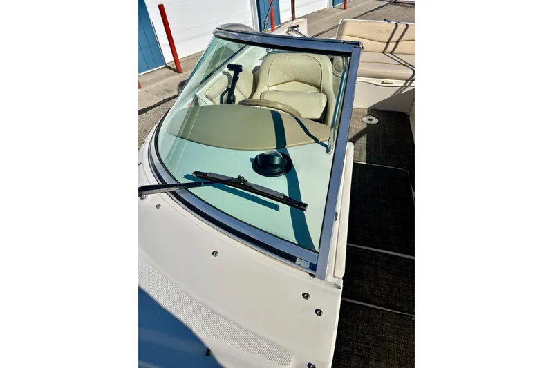 Slide: The Image of 2000 Sea Ray 240 Sundeck interior with beige seating and carpeted floor. - 51