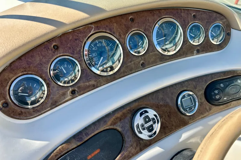 Slide: The Image of Dashboard controls of a 2000 Sea Ray 240 Sundeck boat, featuring Kenwood audio and Lowrance depth gauge. - 57