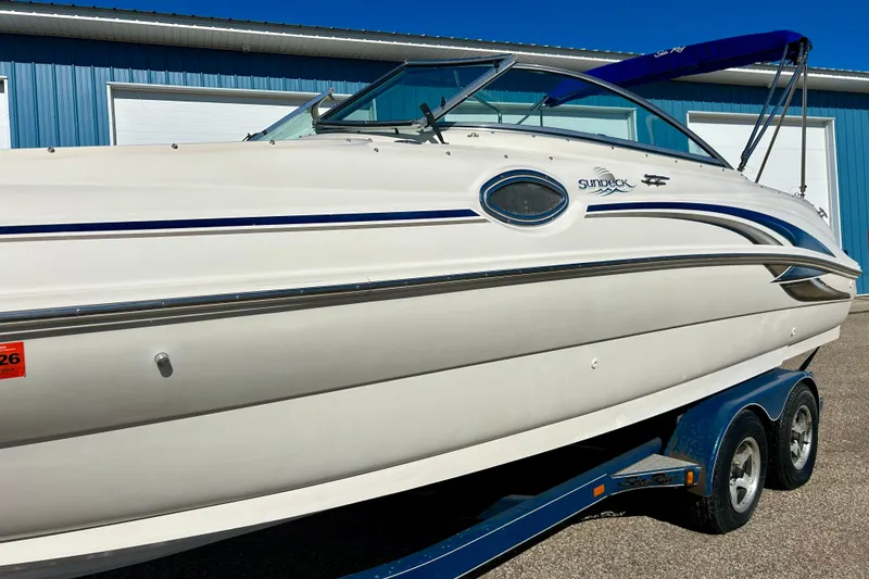 Slide: The Image of 2000 Sea Ray 240 Sundeck boat on trailer, side view with registration number. - 8