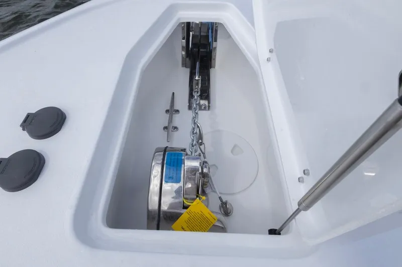 Slide: The Image of Anchor compartment of 2026 Sea Hunt Ultra 275 SE boat, featuring chain and winch. - 10