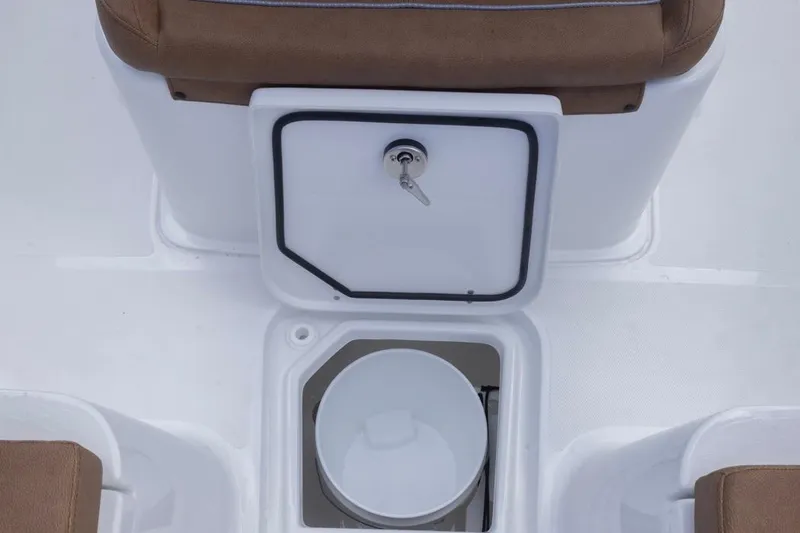 Slide: The Image of 2026 Sea Hunt Ultra 275 SE boat storage compartment with key lock and bucket. - 12