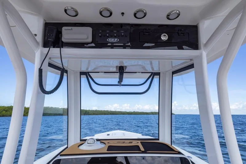 Slide: The Image of Interior view of 2026 Sea Hunt Ultra 275 SE boat with ocean backdrop. - 14