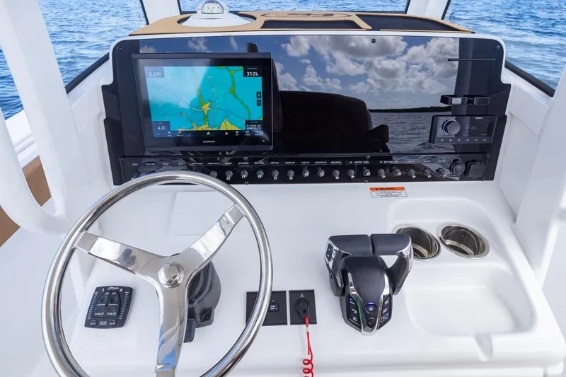 Slide: The Image of Helm of 2026 Sea Hunt Ultra 275 SE with navigation display and controls. - 15