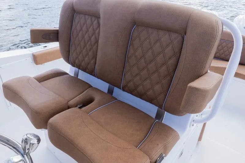 Slide: The Image of Luxurious seating on 2026 Sea Hunt Ultra 275 SE boat, featuring brown diamond-stitched upholstery. - 18