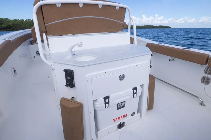 Slide: The Image of 2026 Sea Hunt Ultra 275 SE boat interior with sink and Yamaha cooler. - 25