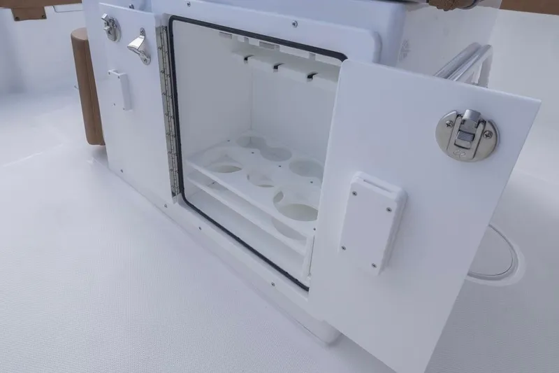 Slide: The Image of Open storage compartment on 2026 Sea Hunt Ultra 275 SE boat, featuring cup holders. - 27