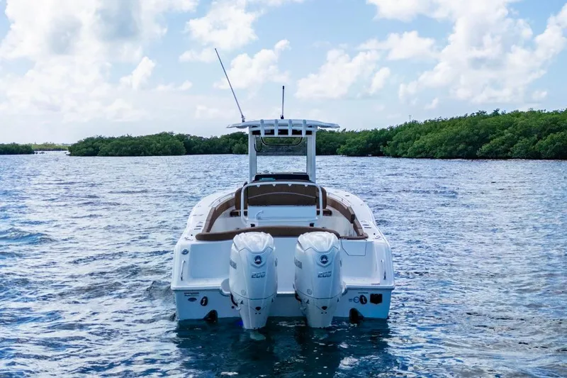 Slide: The Image of 2026 Sea Hunt Ultra 275 SE boat on water, featuring dual engines and sleek design. - 3