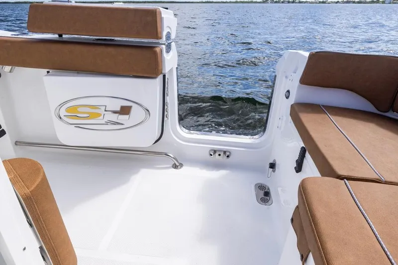 Slide: The Image of 2026 Sea Hunt Ultra 275 SE boat interior with brown seating, open water view. - 30