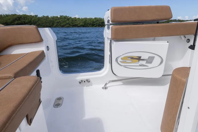 Slide: The Image of 2026 Sea Hunt Ultra 275 SE boat interior with tan seating and SH logo. - 31