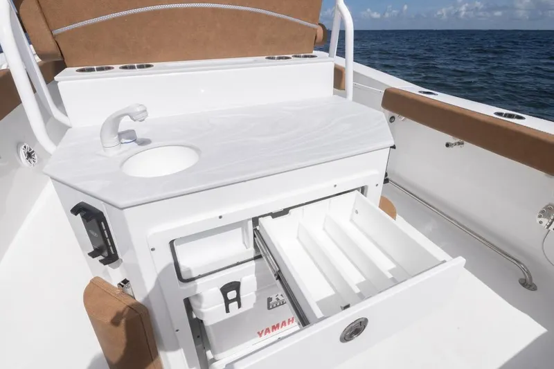 Slide: The Image of 2026 Sea Hunt Ultra 275 SE boat interior with sink and storage drawers. - 32