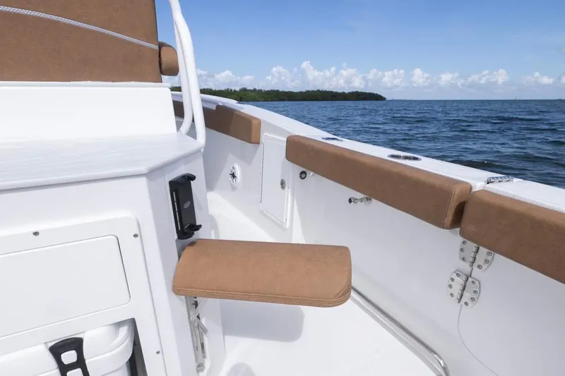 Slide: The Image of 2026 Sea Hunt Ultra 275 SE boat interior with brown seating, ocean view. - 34
