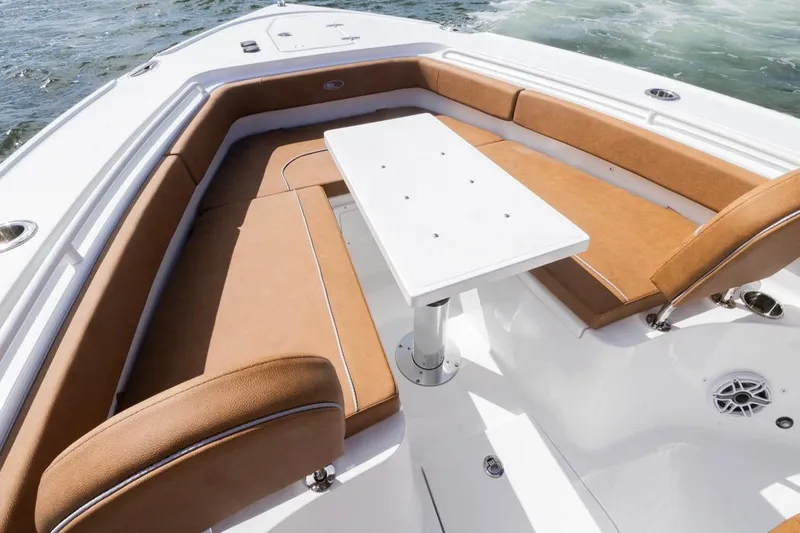 Slide: The Image of 2026 Sea Hunt Ultra 275 SE boat interior with tan seating and white table. - 6
