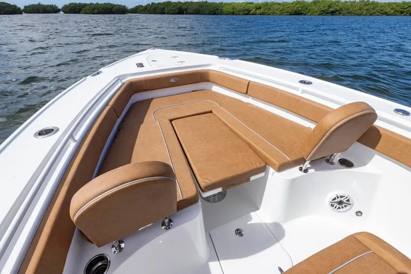 Slide: The Image of 2026 Sea Hunt Ultra 275 SE boat with tan seating on calm water. - 7