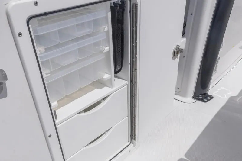 Slide: The Image of Storage compartment on 2026 Sea Hunt Gamefish 27 Forward Seating boat, featuring organized tackle boxes. - 18