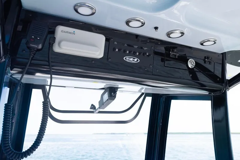 Slide: The Image of 2026 Sea Hunt Gamefish 27 dashboard with Garmin electronics and sleek black paneling. - 22