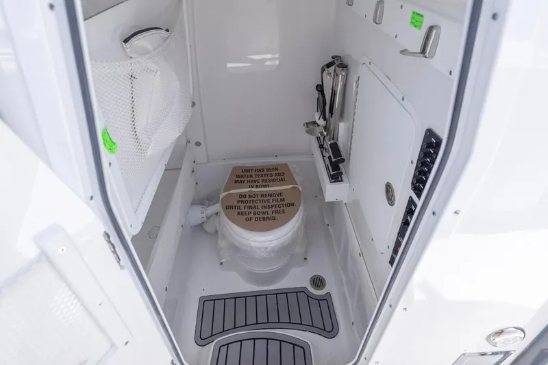 Slide: The Image of 2026 Sea Hunt Gamefish 27 Forward Seating boat interior with compact marine toilet. - 23