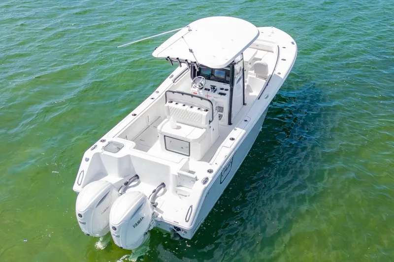 Slide: The Image of 2026 Sea Hunt Gamefish 27 Forward Seating boat on clear green water. - 3